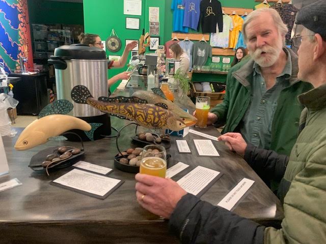  Fish biologist Randy Brown talking with a visitor (next to David's fish sculptures)